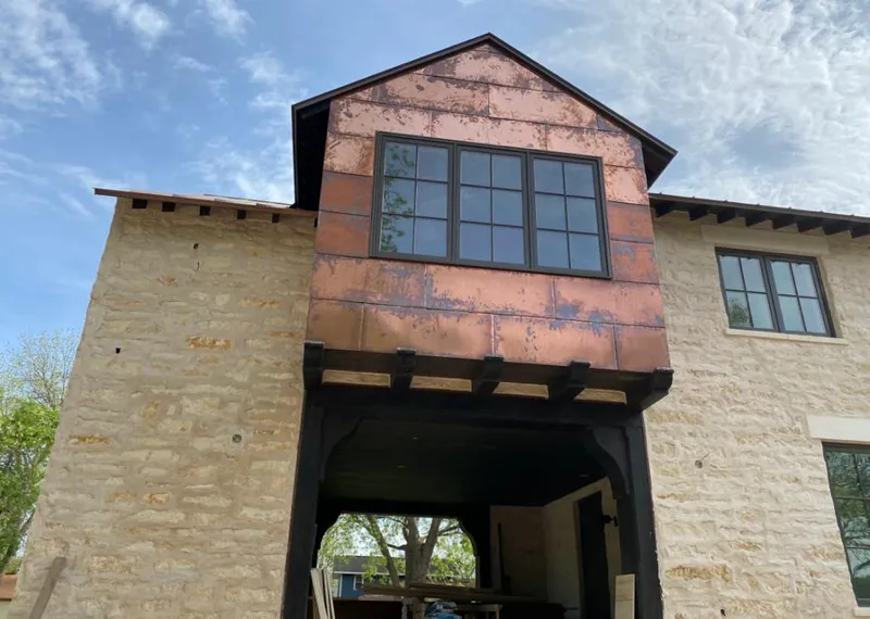 Copper metal panel facade on a stone building for Metal Roof Coating in Piney Green