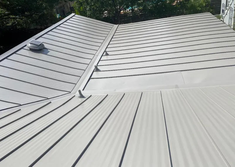 Solar attic fan installed on a metal roof for Roof Ventilation in Piney Green